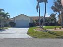 Charming one-story home with a well-maintained lawn, beautiful landscaping, and a two-car garage at 2575 Brazilia Ct, Punta Gorda, FL 33950