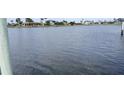 Water view from dock showing water, neighborhood residences across the way, and cloudy skies at 2575 Brazilia Ct, Punta Gorda, FL 33950