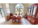 Charming dining room with a large window, neutral walls, and tile flooring at 10203 Windsong Rd, Punta Gorda, FL 33955