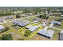 Aerial view of the property, showcasing its location within a neighborhood with mature trees at 1069 Fergus Ln, Punta Gorda, FL 33983