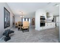 The dining room is open to the kitchen and living spaces and features tile floors at 12420 Minot Ave, Port Charlotte, FL 33981
