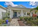 Inviting covered front porch with white columns and well-maintained landscaping at 12472 Davie Ct, Venice, FL 34293