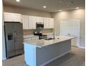 Modern kitchen with stainless steel appliances, granite counters and a large island at 198 Arch Dr, Rotonda West, FL 33947