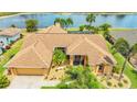 Stunning waterfront home boasts a charming exterior with well-manicured landscaping and a spacious two-car garage at 2202 Peterborough Rd, Punta Gorda, FL 33983