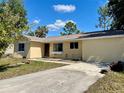 Single-story home featuring a front yard and a concrete driveway leading up to the house at 2314 Lee Ter, Port Charlotte, FL 33952