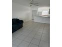 Open living area with tiled floors connecting to the kitchen and entrance door at 25050 Sandhill Blvd # B3, Punta Gorda, FL 33983