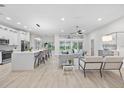 Bright and airy open-concept living room with modern decor and seamless flow to the outdoor pool area at 2531 Pebble Creek Pl, Port Charlotte, FL 33948