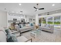 Open-concept living room flows to kitchen and dining areas, with sliding glass doors to the pool at 2531 Pebble Creek Pl, Port Charlotte, FL 33948