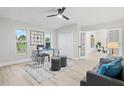 Well-lit home office with large windows, stylish furniture, and convenient access to other rooms at 2531 Pebble Creek Pl, Port Charlotte, FL 33948