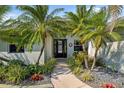 Charming front entrance with palm trees and tasteful landscaping creating a welcoming curb appeal at 265 White Marsh Ln, Rotonda West, FL 33947