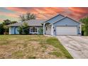 Charming single-story home featuring a manicured lawn and a two-car garage at 2685 Nanette Ln, North Port, FL 34286