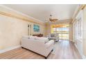 Cozy living room featuring neutral furniture, ceiling fan, and sliding door to a balcony with water views at 3228 Purple Martin Dr # 116, Punta Gorda, FL 33950
