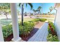 Home exterior featuring well-manicured landscaping, brick walkway, and view of the surrounding community at 327 Monaco Dr # 12, Punta Gorda, FL 33950