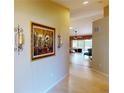Hallway showcasing neutral paint, decorative sconces, and views of the living spaces at 327 Monaco Dr # 12, Punta Gorda, FL 33950