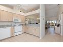 Well-lit kitchen with modern appliances, light wood cabinets, and an open layout into the living space at 4260 Placida Rd # 13B, Englewood, FL 34224
