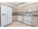 Bright kitchen featuring white appliances, plenty of cabinet storage, and granite countertops at 4260 Placida Rd # 13B, Englewood, FL 34224