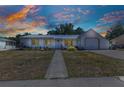 Charming single-story home with a concrete walkway leading to the front door, complemented by a two-car garage and cozy landscaping at 4359 Pocatella Ave, North Port, FL 34287
