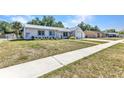 Welcoming single-story residence featuring a neatly kept front yard, concrete walkway, and an attached one car garage at 4359 Pocatella Ave, North Port, FL 34287