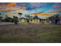 Beautiful home with a lush lawn and a cozy front porch perfect for enjoying evening sunsets at 4474 Ozark Ave, North Port, FL 34287