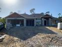 New construction home featuring a modern design with a sturdy block foundation and dark roof at 47 Tee View Rd, Rotonda West, FL 33947