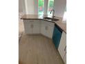 Kitchen island boasts granite countertop, stainless sink, and modern appliances at 47 Tee View Rd, Rotonda West, FL 33947