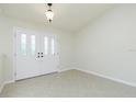 Bright foyer with tile flooring and a view of the decorative glass front door at 5611 Ganyard Ave, North Port, FL 34291
