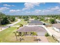 Charming single-story home featuring a well-maintained lawn, palm trees, and an attached two-car garage at 6235 Bixel Ln, Englewood, FL 34224