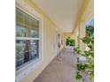 Inviting front porch with seating, decorative flamingo, and plant accents at 6235 Bixel Ln, Englewood, FL 34224