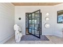Welcoming front door with artful sculpture, custom lighting, and views to the interior at 810 Napoli Ln, Punta Gorda, FL 33950