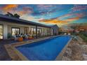 Gorgeous backyard pool with comfortable seating, a dining area, and lush landscaping creating a private oasis at 810 Napoli Ln, Punta Gorda, FL 33950