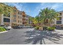 A condominium building featuring well-maintained landscaping, parking, and vibrant architecture against a blue sky backdrop at 98 Vivante Blvd # 9834, Punta Gorda, FL 33950