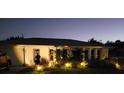Single-story home featuring manicured landscaping and exterior lighting adding charm and curb appeal at 11105 Pendleton Ave, Englewood, FL 34224