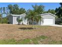 Charming single-Gathering home featuring a spacious front yard and a two-car garage at 11136 Grapefruit Ln, Punta Gorda, FL 33955