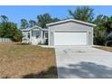 Charming single-Gathering home featuring a spacious front yard and a two-car garage at 11136 Grapefruit Ln, Punta Gorda, FL 33955