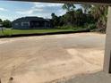 View of spacious backyard with room for a pool, and a beautiful screen enclosed porch in the background at 112 Cougar Way, Rotonda West, FL 33947
