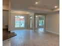 Bright and airy living room featuring large windows, tile flooring, and an open floor plan at 112 Cougar Way, Rotonda West, FL 33947