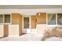 Condo 134 featuring wood paneling, new front door, and tiled front porch at 150 Harborside Ave # 134, Punta Gorda, FL 33950