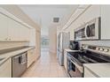 Efficient kitchen layout with stainless steel appliances and ample cabinet space at 18135 Lake Worth Blvd, Port Charlotte, FL 33948