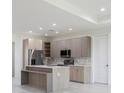 Bright kitchen featuring stainless steel appliances, a center island, and modern cabinetry at 1816 Braddock Ave, North Port, FL 34288