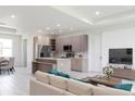 Spacious living room with modern kitchen island featuring granite countertop and stainless appliances at 1816 Braddock Ave, North Port, FL 34288