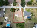 Aerial view of the property showing the boundaries, roof, driveway, and surrounding neighborhood at 21035 Exmore Ave, Port Charlotte, FL 33952