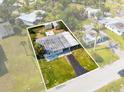 Aerial view of a single-story home with a driveway, carport and shed at 23491 Harper Ave, Punta Gorda, FL 33980