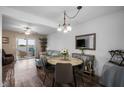 Cozy living room with dining area, lake view, and access to the sunroom at 26290 Rampart Blvd # D, Punta Gorda, FL 33983
