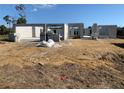 Image of new home construction showing the block walls being erected on a dirt lot under a clear blue sky at 277 Long Meadow Ln, Rotonda West, FL 33947