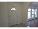 Bright entryway with tile floors, white door, and arched doorway into the living area at 29211 Picador St, Punta Gorda, FL 33982