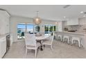 Eat-in dining area near kitchen features water views, modern lighting and white table and chairs at 3016 Curry Ter, Port Charlotte, FL 33981