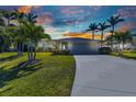 Charming single-story home with an attached two-car garage, lush lawn and a driveway at 3016 Curry Ter, Port Charlotte, FL 33981