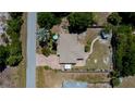 Overhead view of a well-maintained home with mature trees, manicured lawns, and a brick driveway and walkways at 3051 Chicory Ter, Punta Gorda, FL 33983