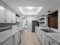Bright kitchen features white cabinetry, modern appliances, and a skylight offering natural light at 3561 Middletown St, Port Charlotte, FL 33952
