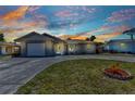 Charming single-story home with a well-manicured lawn and a driveway leading to the attached garage at 428 Briarwood Rd, Venice, FL 34293